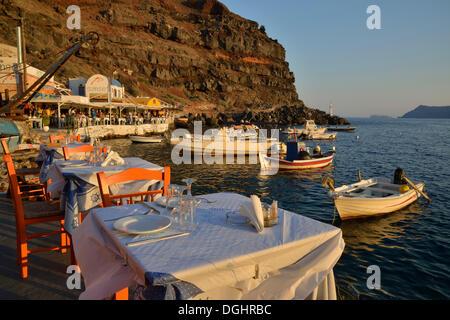 View from the Katína restaurant to the fishing boats in the harbour of Ammoúdi, Ammoúdi Bay near Oia, Santorini, Cyclades Stock Photo