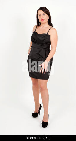 Young woman wearing a black evening dress Stock Photo