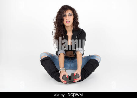Young woman wearing a short jacket, jeans and boots Stock Photo