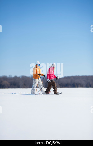 Adult couple walking on snow Stock Photo