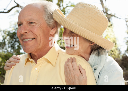 Wife hugging husband from behind Stock Photo