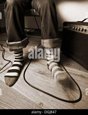A foot tapping in time with music. Stock Photo