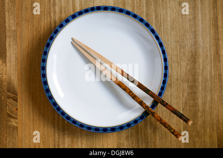 Plate on a table with chopsticks. Stock Photo
