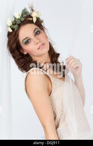 Young woman with a flower arrangement as a headdress