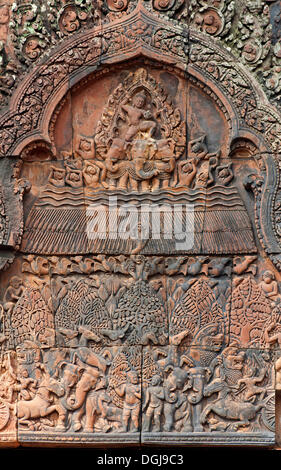 Indra, god of the sky, releasing rain in an attempt to extinguish the fire created by Agni, part of the bas-reliefs of the Stock Photo