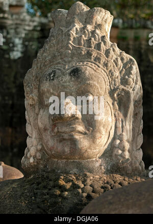 Detail of a figure from the right boundary of the access road to the south gate, Gopura, of Angkor Thom where stone figures Stock Photo