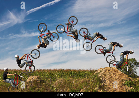 Man performing stunt on bmx bike, digital composite Stock Photo