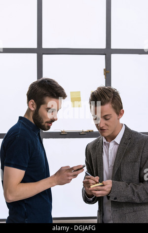 Two young male designers sharing ideas