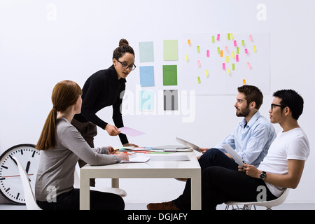 Design team sitting at table discussing ideas Stock Photo