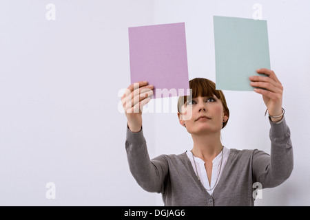 Female designer comparing color samples Stock Photo
