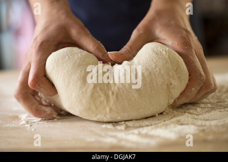 Close up of hands kneading bread dough Stock Photo