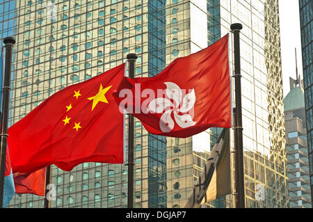 Flags of China and Hong Kong in front of an office building, Hong Kong, Hong Kong, China, People's Republic of China Stock Photo