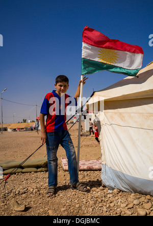 Syrian Refugee Child With A Barcelona Shirt In Front Of His Tent, Erbil, Kurdistan, Iraq Stock Photo