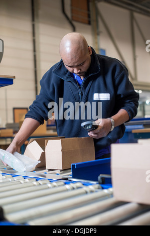 Male warehouse worker checking barcode scanner Stock Photo