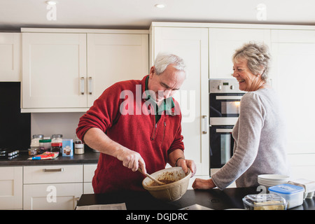 Senior couple baking in kitchen Stock Photo