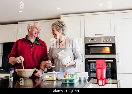 Senior couple baking together in kitchen Stock Photo