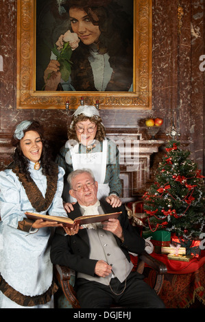 Victorian family singing Christmas carols Stock Photo