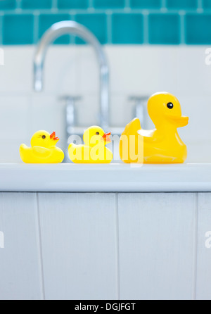 Row of three yellow rubber ducks for bathtime Stock Photo