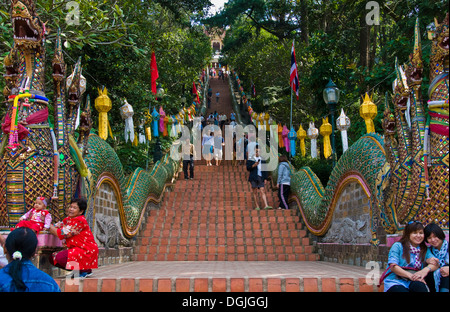 People climbing and descending the 300 steps up to Wat Phra That Doi Suthep in Chiang Mai. Stock Photo