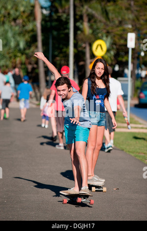 Teenagers skateboarding along the seafront at Mooloolaba on the Sunshine Coast in Queensland. Stock Photo