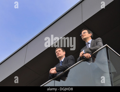 Two office colleagues on balcony, low angle Stock Photo