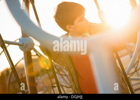 Boy on rope swing in playground Stock Photo