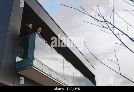 Two office colleagues on balcony, low angle Stock Photo