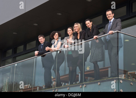 Six office colleagues on balcony Stock Photo