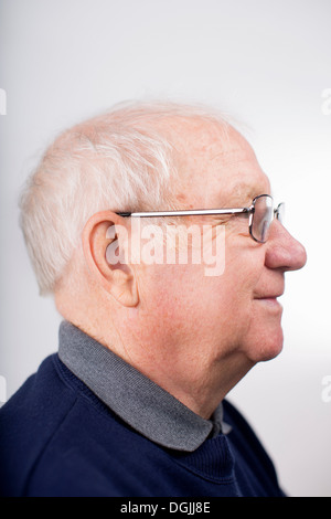 Profile of senior man wearing glasses, studio shot Stock Photo