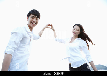 a couple making a heart with their hands Stock Photo