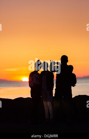 Taking pictures with a smartphone under the Midnight Sun, Seltjarnarnes, Reykjavik, Iceland Stock Photo
