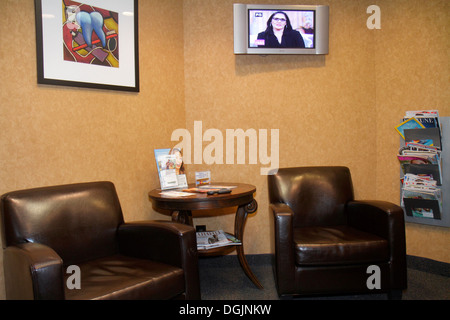 Miami Beach Florida,dentist's office,dentist,waiting room,area,chairs,flat screen TV television,magazines,visitors travel traveling tour tourist touri Stock Photo