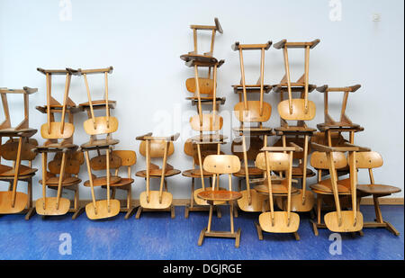 Old chairs stacked in a school, Bavaria Stock Photo