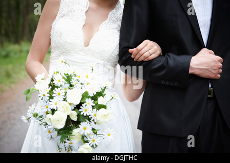 newlyweds standing on the road in the nature Stock Photo