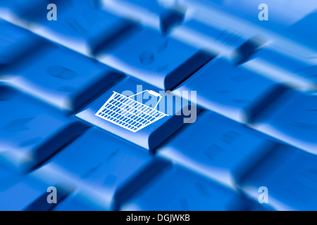 Close up of shopping basket on computer keyboard online Internet shopping concept Stock Photo