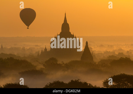 Sunrise with balloons over the pagodas of Bagan in Myanmar. Stock Photo