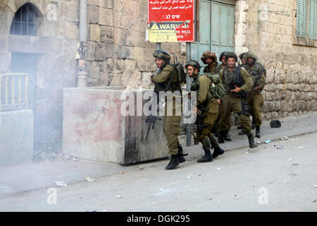 Hebron, West Bank, Palestinian Territory, . 22nd Oct, 2013. Israeli soldiers take position during clashes with Palestinian youths in the West Bank city of Hebron, after killing of Palestinian Islamic Jihad militant Mohamed Assi in Bilin near Ramallah, Tuesday, Oct. 22, 2013. Israel's security service and the military said Israeli forces killed the Palestinian man in the West Bank believed responsible for a Tel Aviv bus bombing in 2012 Credit:  Mamoun Wazwaz/APA Images/ZUMAPRESS.com/Alamy Live News Stock Photo