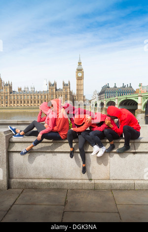 Small group of young people performing together on wall Stock Photo