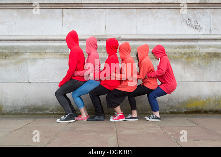 Small group of young people performing on city street Stock Photo