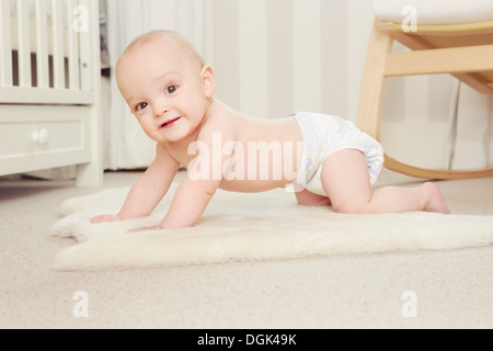 Baby boy crawling on rug Stock Photo