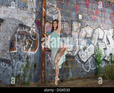 Ballet dancer by wall with graffiti Stock Photo