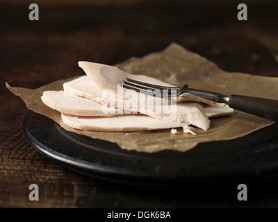 Still life of sliced chicken on waxed paper Stock Photo