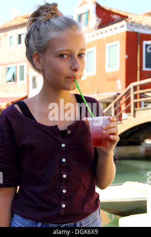 Cute girl with red slush drink, close up Stock Photo