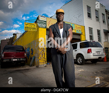 Portrait of car mechanic standing outside garage Stock Photo