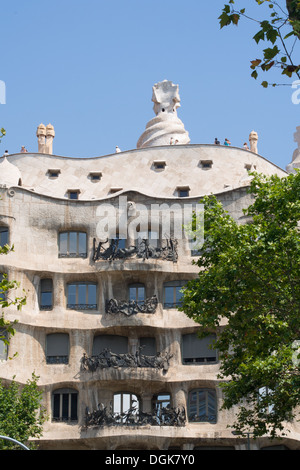 (Centre) Antoni Gaudi's 'Casa Mila' better known as 'La Pedrera' , built with a limestone facade, Barcelona, Catalonia, Spain. Stock Photo
