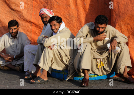 Dock workers taking a break on Dubai Creek. Stock Photo