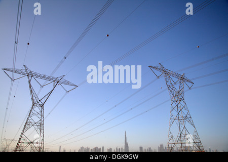 Pylons and the Dubai cityscape against the sky. Stock Photo