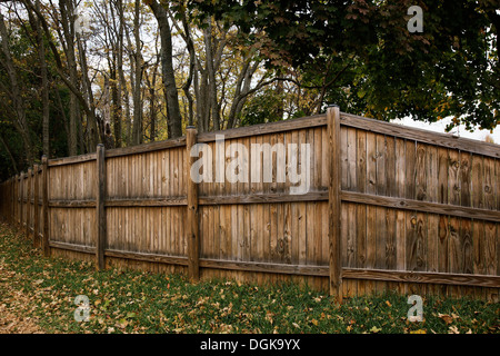 Wooden fence enclosing trees Stock Photo