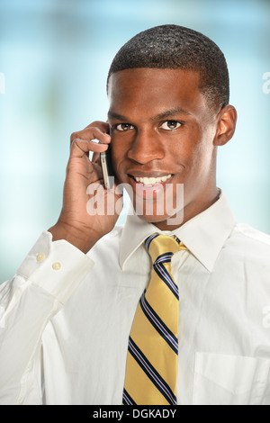 African American businessman using cell phone inside office building Stock Photo