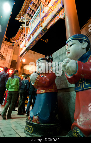 Figures in front of entry to Wangfujing Snack Street in Dongcheng District, Beijing, China Stock Photo